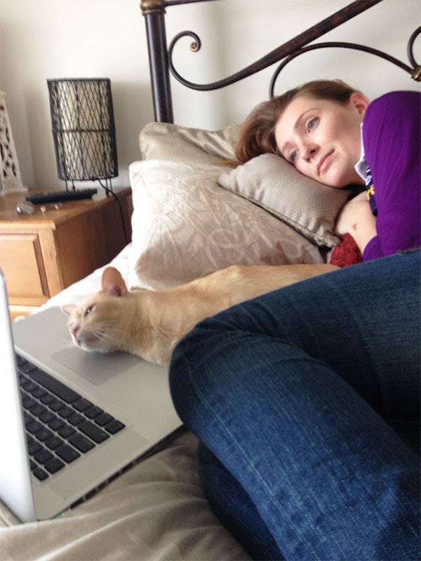 Woman in bed with cat