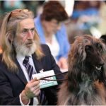 Guy at dog show with his dog