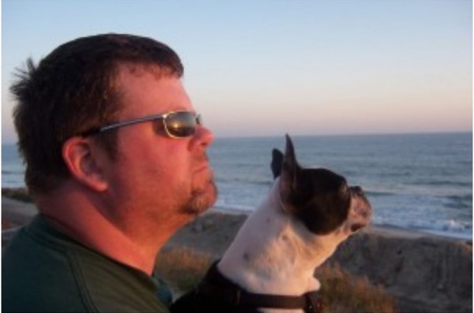 At beach with his dog