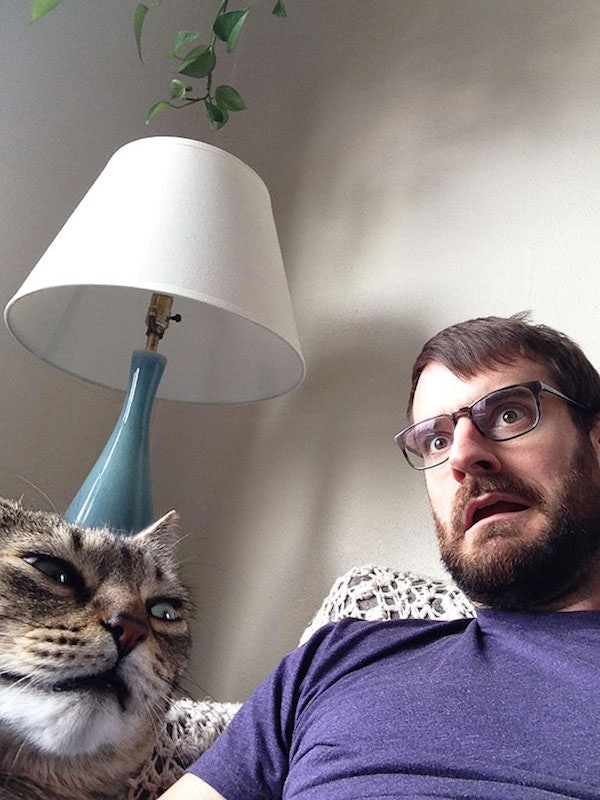 Making faces with his cat
